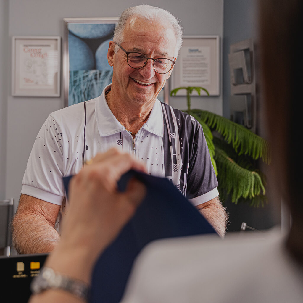 Client at Battell Denture Clinic talking to Trish at the reception area