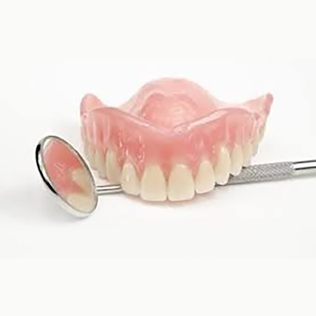 Denture model with a dental mouth mirror under it
